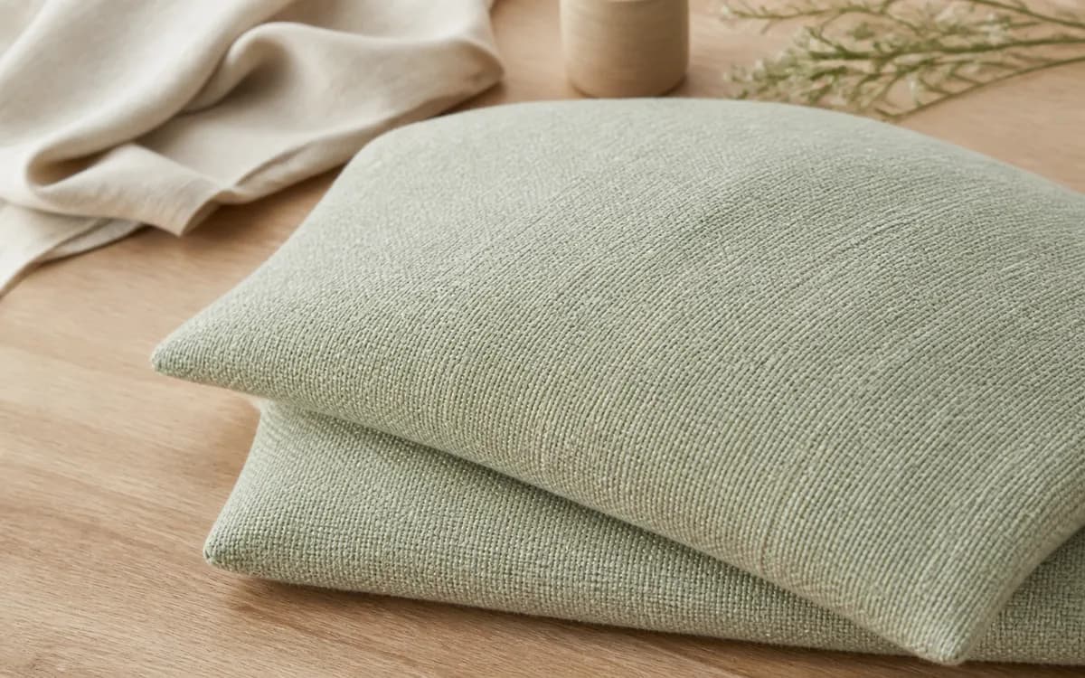 Editorial still life of coral home textiles, representing home textiles sourcing in Ahmedabad, Gujarat
