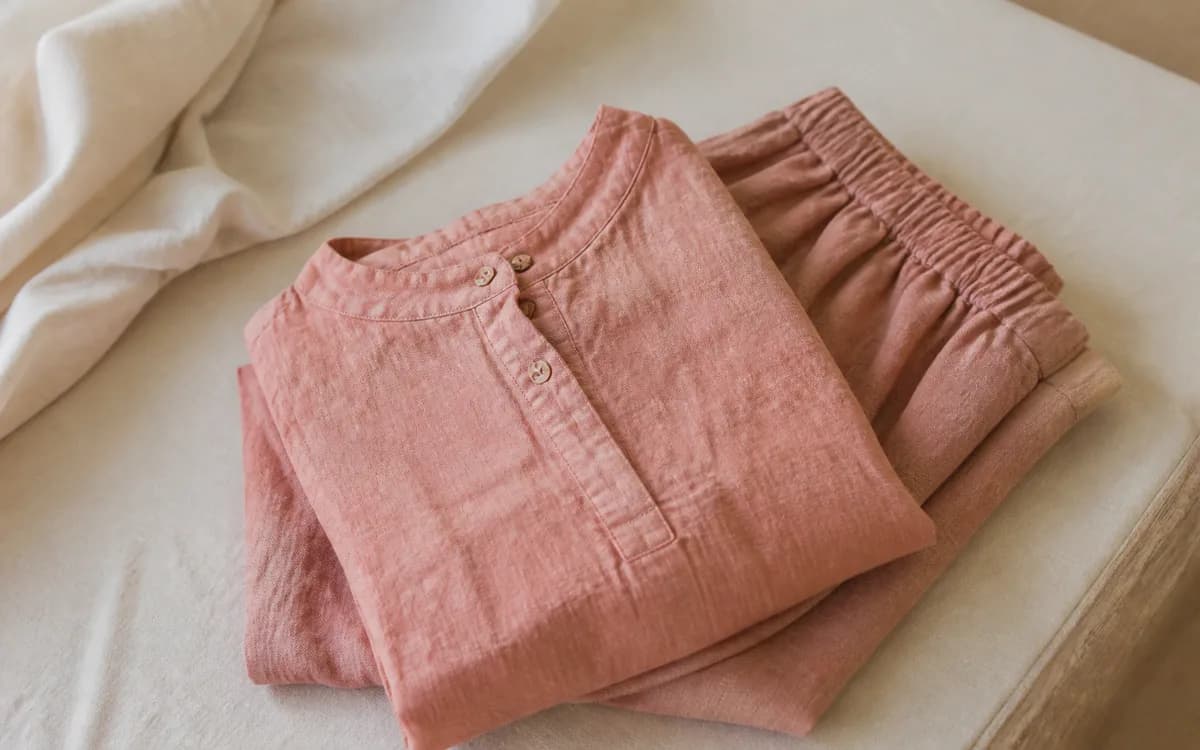Editorial still life of sage cotton clothing, representing readymade garments sourcing in Meerut, Uttar Pradesh